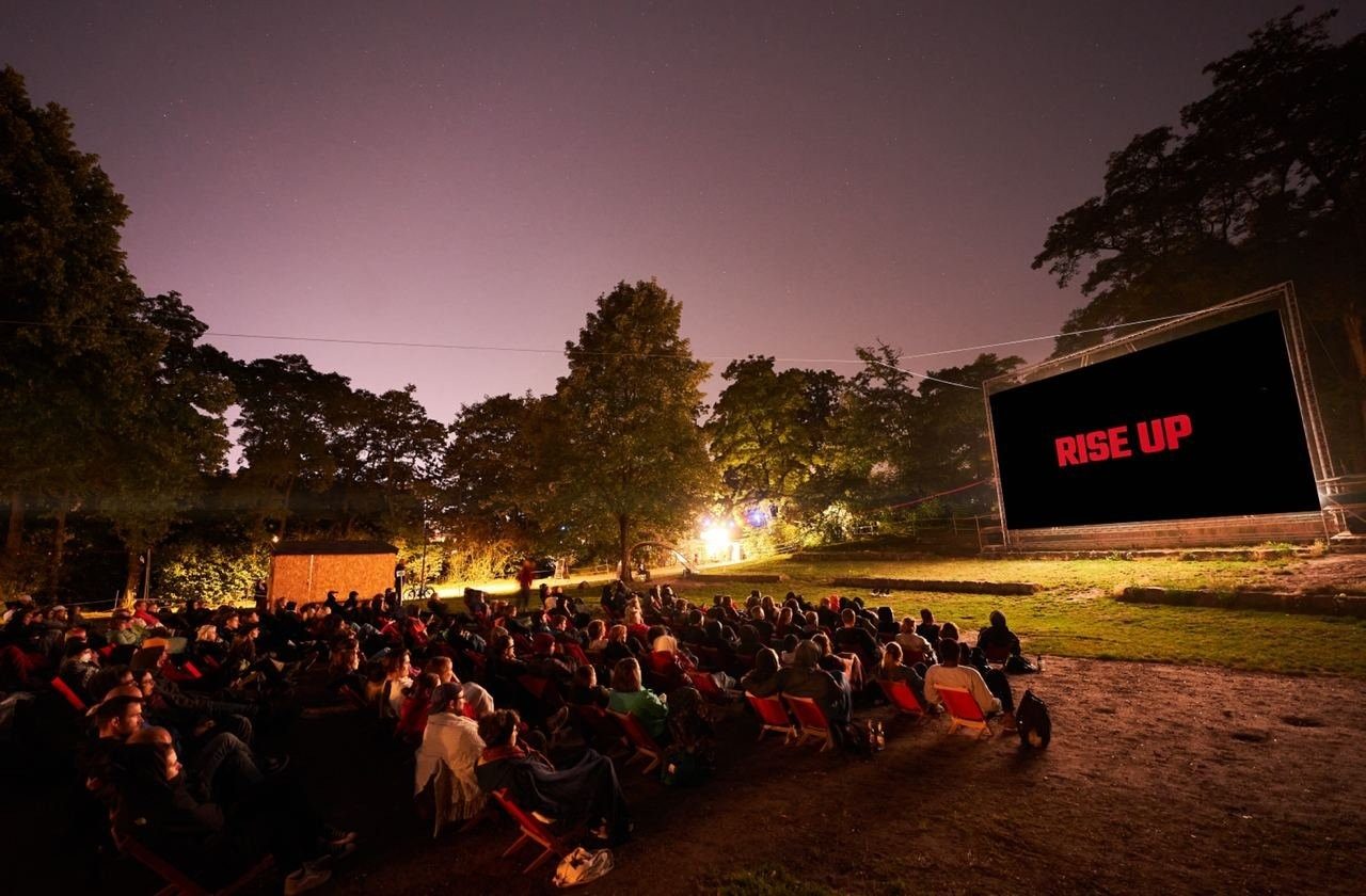 Freiluftkino-Vorführung von RISE UP in der Abenddämmerung